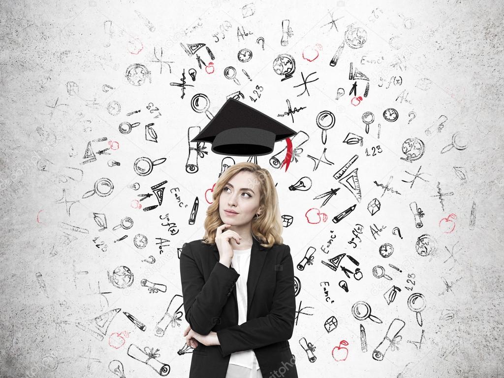 Redhead  girl with levitating graduation hat and education sketc