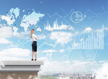 Woman looking at graphs and world map in the sky