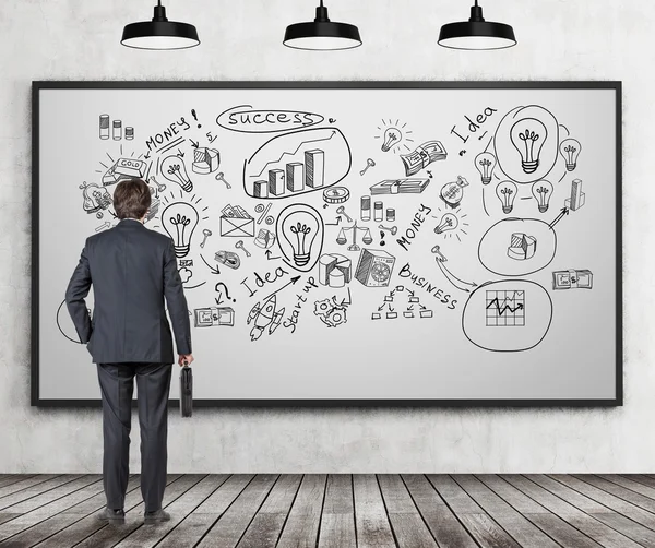 Man with suitcase looking at icons — Stock Photo, Image