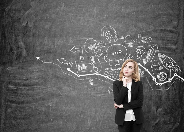 Girl with red hair and graph on blackboard — Stock Photo, Image