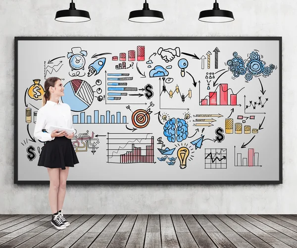 Woman in wide skirt standing near business doodles — Stock fotografie