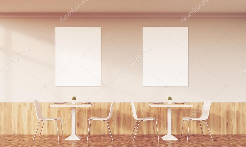 Sunlit family cafe with two posters
