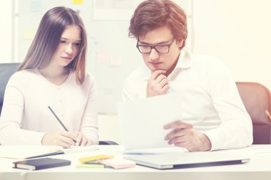 Young people discussing business report