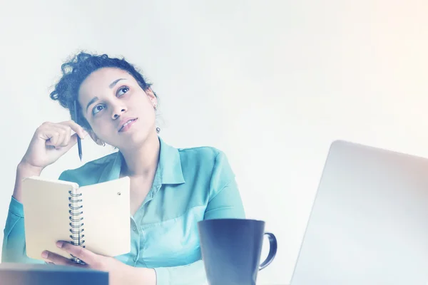 Thoughtful black woman in green — Stock Photo, Image