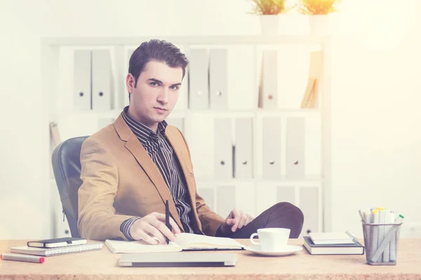 Thoughtful man at office desk  with coffee — Stock Photo, Image