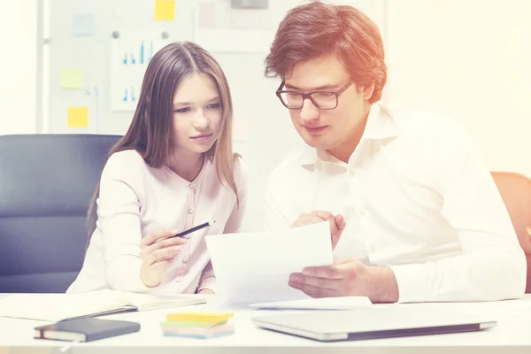 Teamworking young businesspeople in sunlit office — Stock Photo, Image