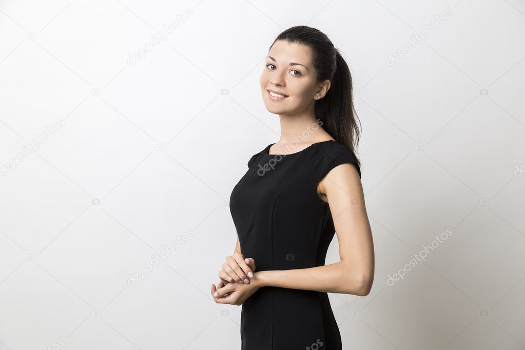 Side view of smiling young woman in long black dress