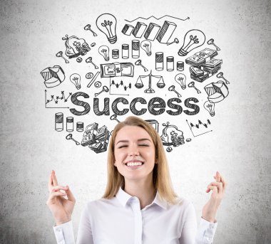 Woman with crossed fingers and success sketch on concrete wall
