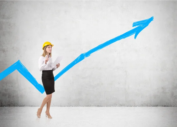 Girl in hard hat and blue graph — Stock Photo, Image