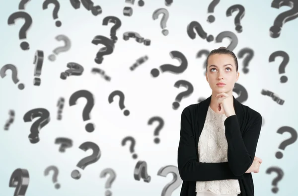 Woman in black and white clothes and floating question marks — Stock Photo, Image