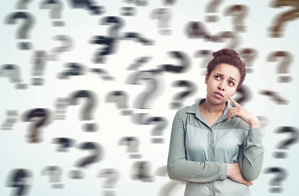 African girl and floating blurred question marks — Stock Photo, Image