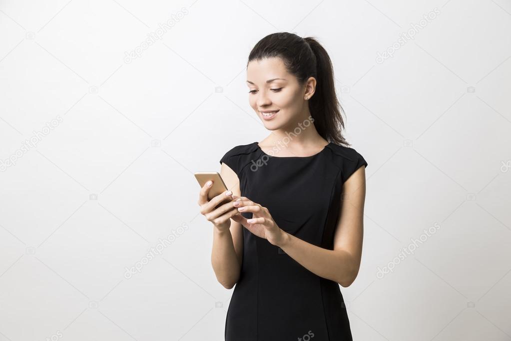 Close up of woman in long black dress talking on her phone