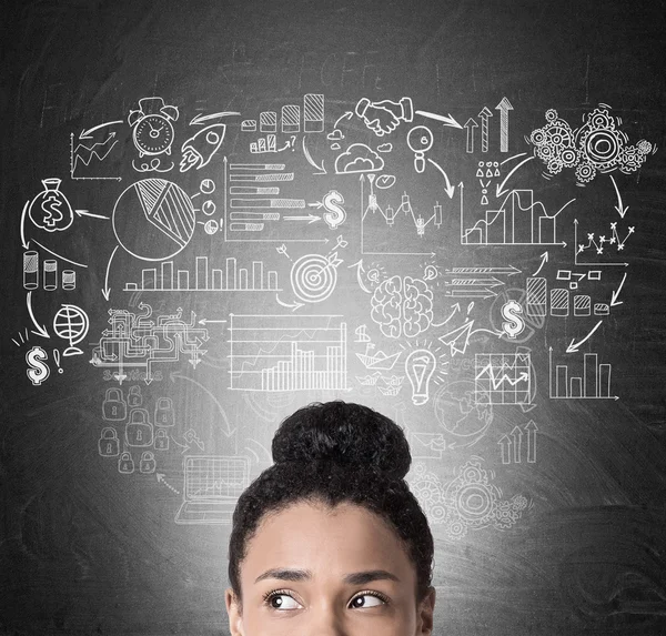African girl's head and business icons on blackboard — Stock Photo, Image