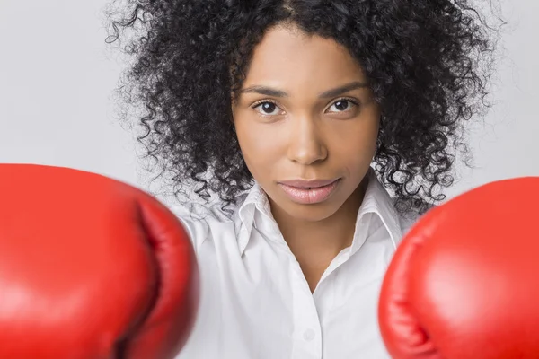 Determined African American girl with boxing gloves
