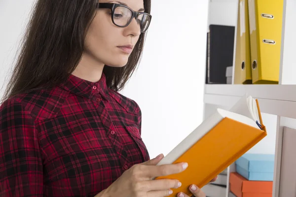Nerdy girl is reading a sci-fi book — Stock Photo, Image