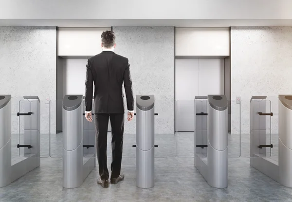 Man entering office via turnstile — Stock Photo, Image