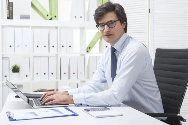 Young successful businessman in white office — Stock Photo, Image