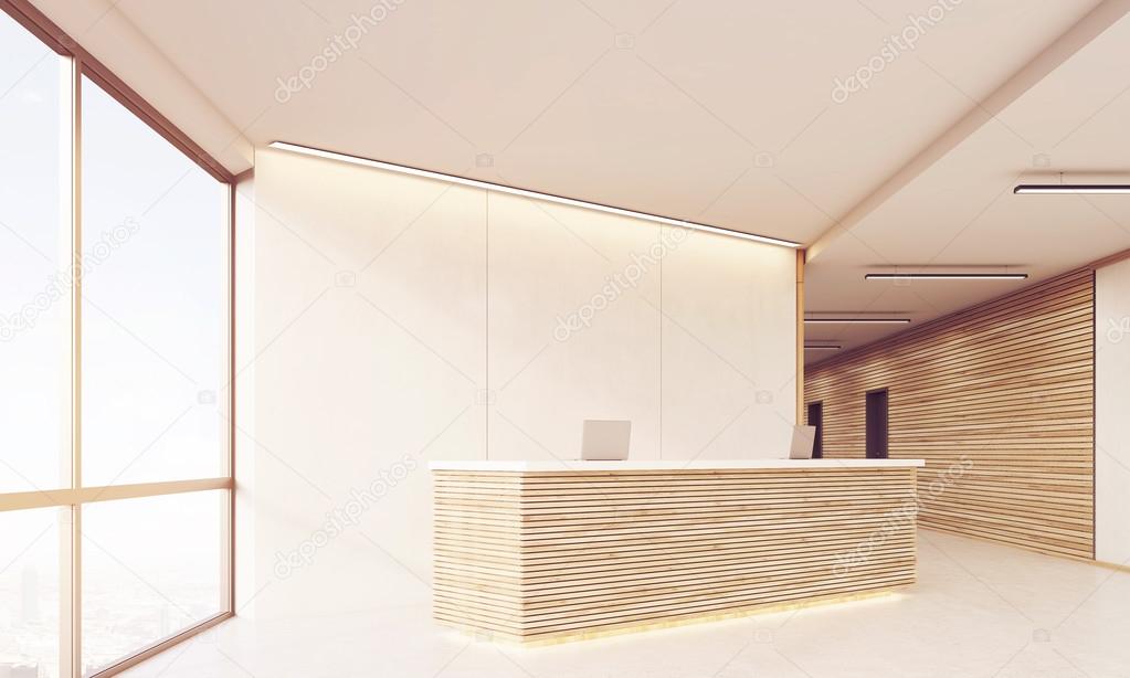 Side view of reception desk in long sunlit corridor