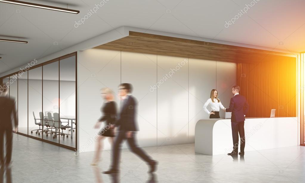 Men and women in busy office lobby