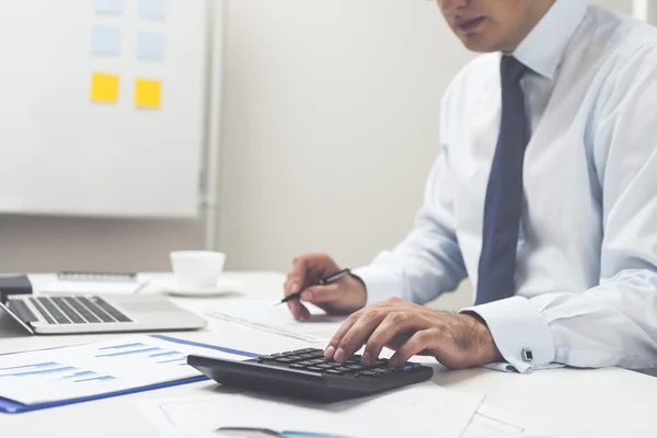 Office medewerker met Rekenmachine en pen — Stockfoto