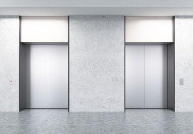 Beton duvarlar ile koridorda iki kapalı asansörler