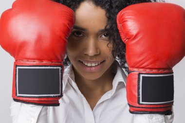 Close up of smiling African American girl with red boxing gloves clipart