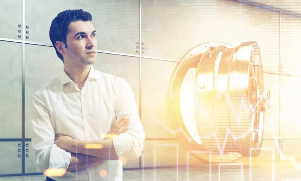 Man in white shirt near open vault with graphs