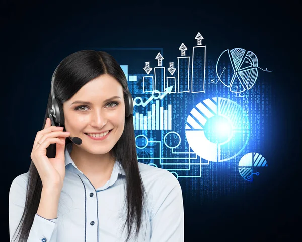 Woman with headset and glowing graphs — Stock Photo, Image