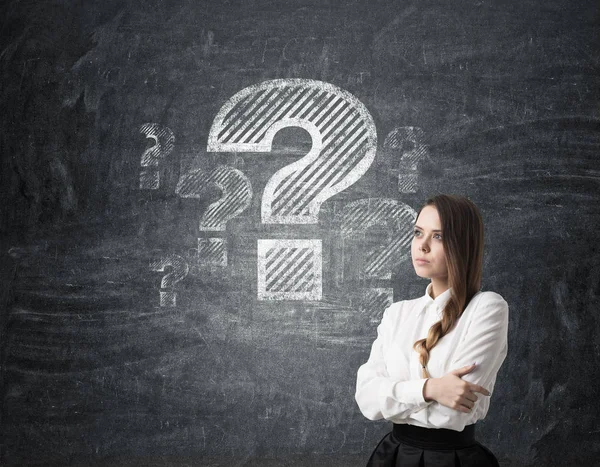 Woman with braided hair and large question mark on chalkboard — Stock Photo, Image