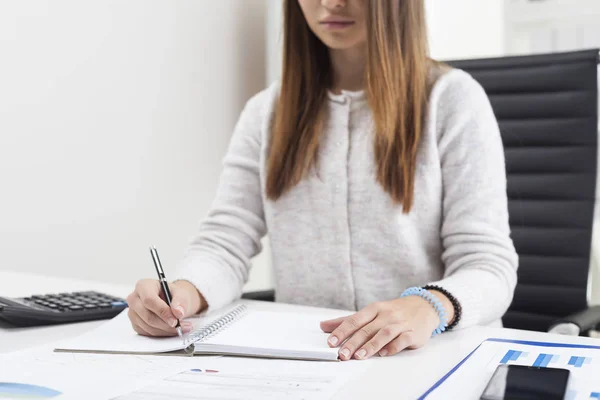 Girl is making notes at work — Stock Photo, Image