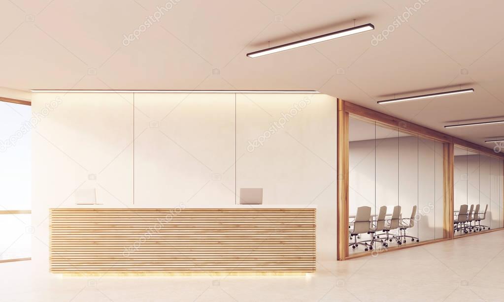 Front view of reception desk in long sunlit corridor