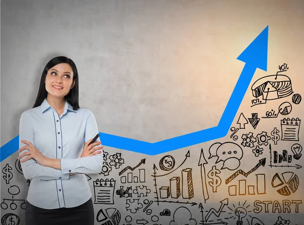 Girl with black hair near concrete wall with blue graph — Stock Photo, Image