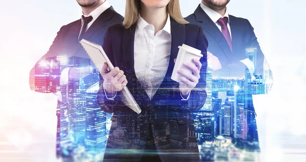 Close up of business trio and a night cityscape — Stock Photo, Image