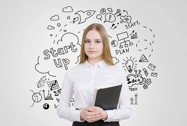 Girl with notebook near a startup sketch — Stock Photo, Image