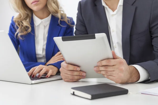 Close up of man's hands with a tablet sitting near a girl at wor — Stock Photo, Image