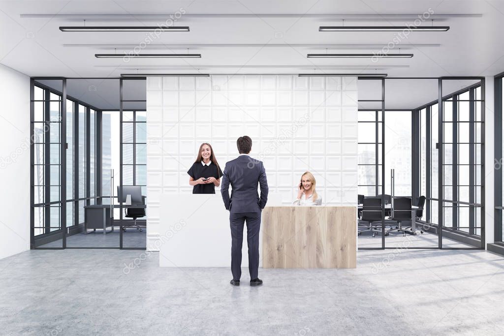 People standing in an office lobby with tiles