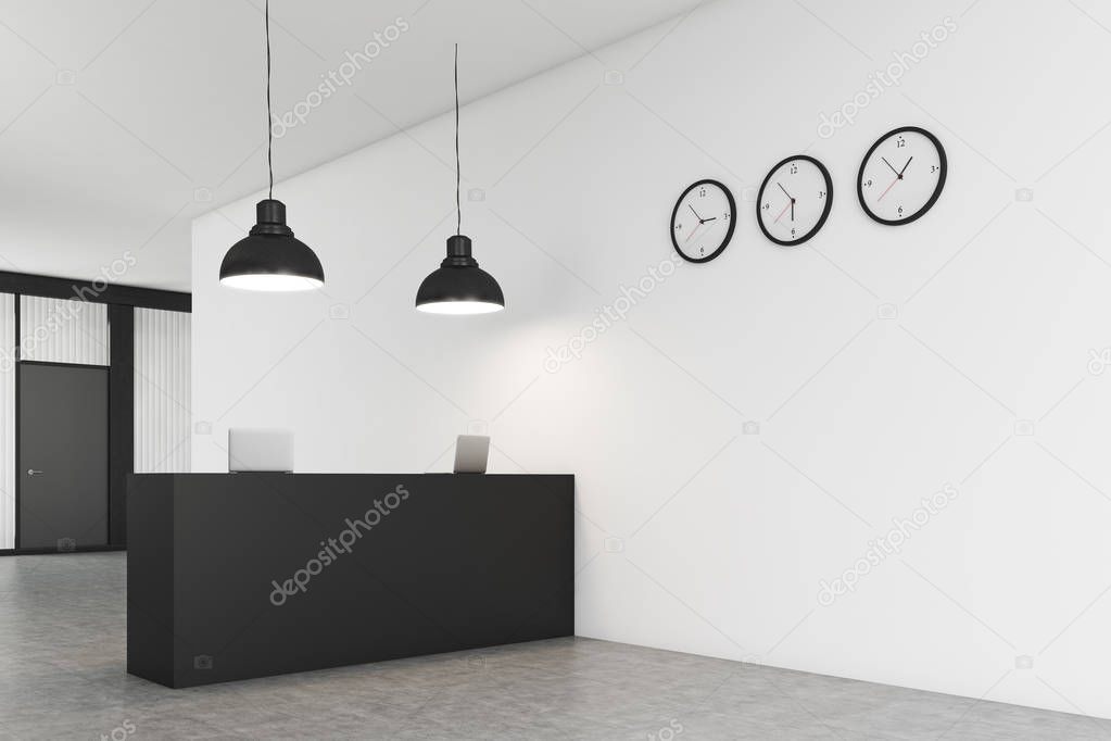 Side view of an office counter with three clocks