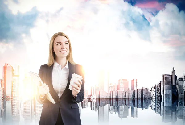 Businesswoman with coffee in a city — Stock Photo, Image