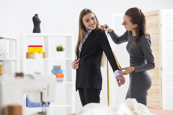 Kvinna i grått mäter sin klients ärm — Stockfoto