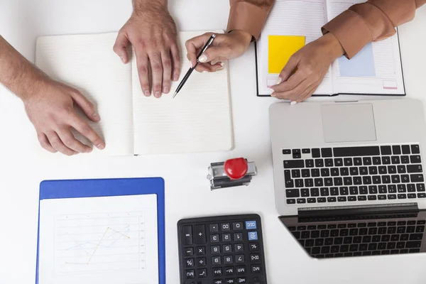 Man and woman's hands on desk — Stock Photo, Image