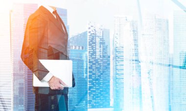 İşadamı ofisinde bir dizüstü bilgisayar, holding cityscape