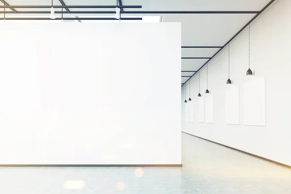 Art gallery with large white wall and pictures, toned — Stock Photo, Image