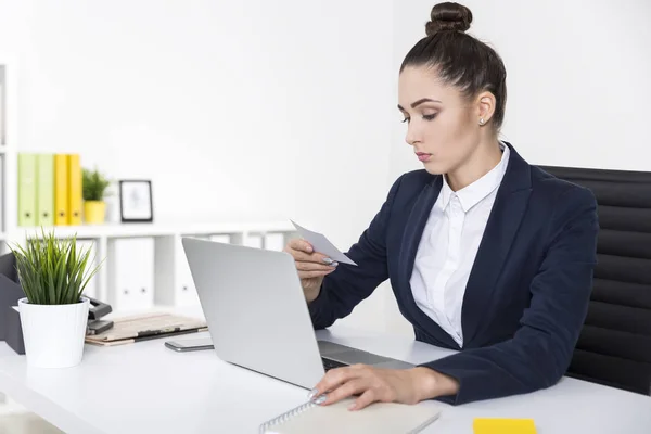 Una mujer de negocios seria está leyendo una nota —  Fotos de Stock