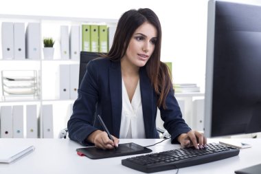 Güzel kahverengi saçlı kız onun kalem tablet ile çizim