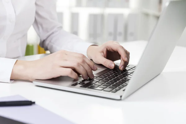 Woman with short nails typing — Stock Photo, Image