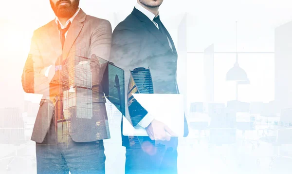 Two businessmen in office with skyscrapers, toned — Stock Photo, Image