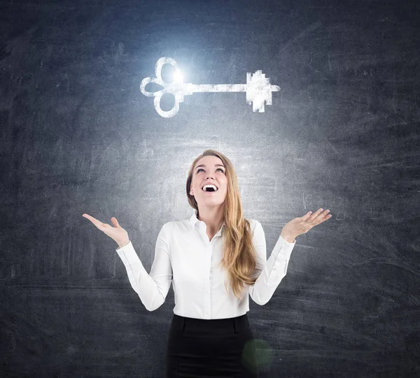 Blond woman happy to see a key sketch — Stock Photo, Image