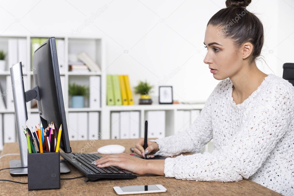 Side view of a graphic designer in a white sweater