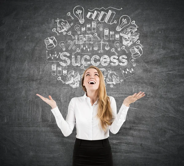 Happy woman near a success sketch on a blackboard — Stock Photo, Image