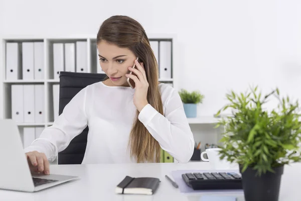 Mujer en oficina blanca en su teléfono — Foto de Stock